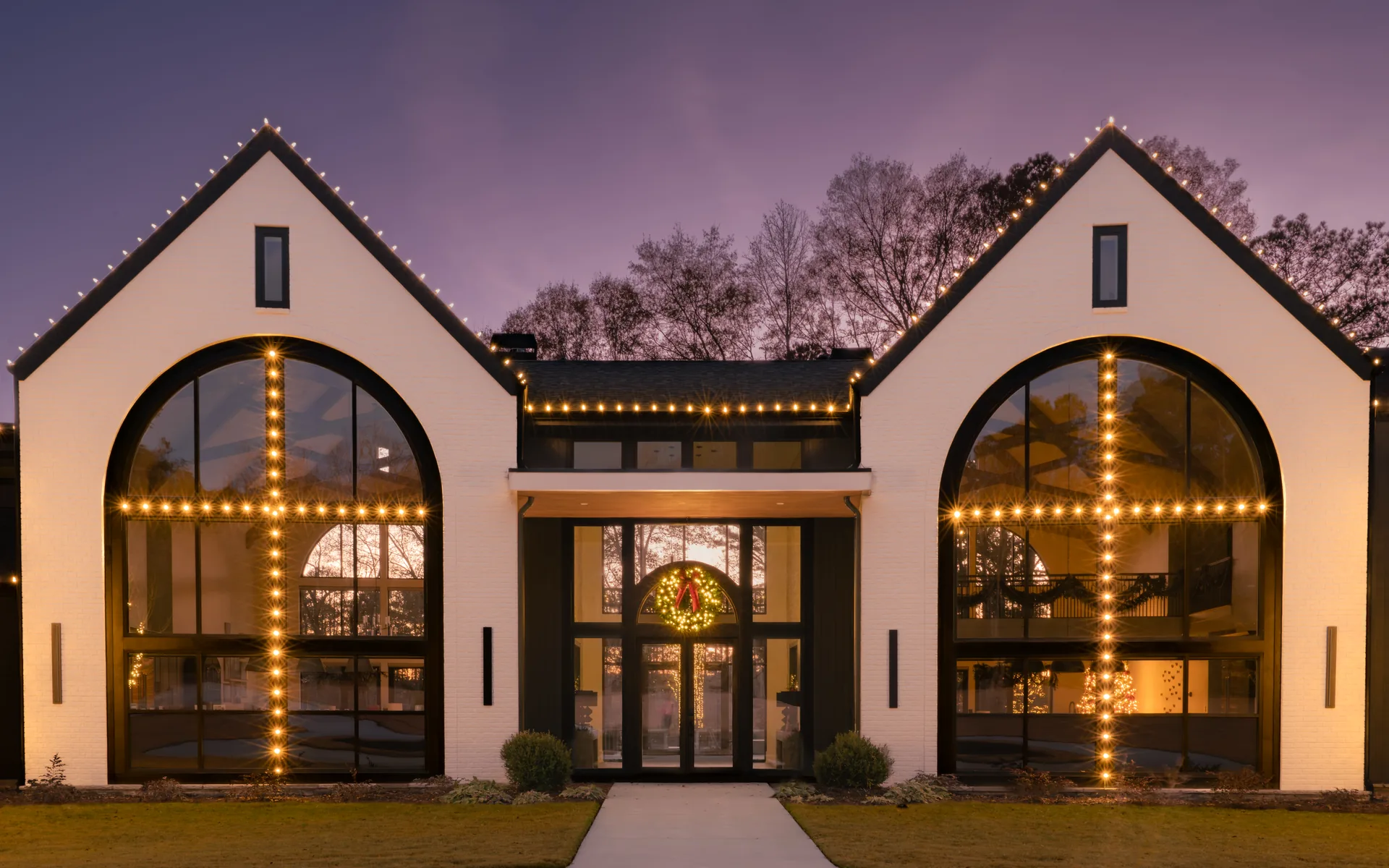 Professional Christmas light installation on an Atlanta home at dusk