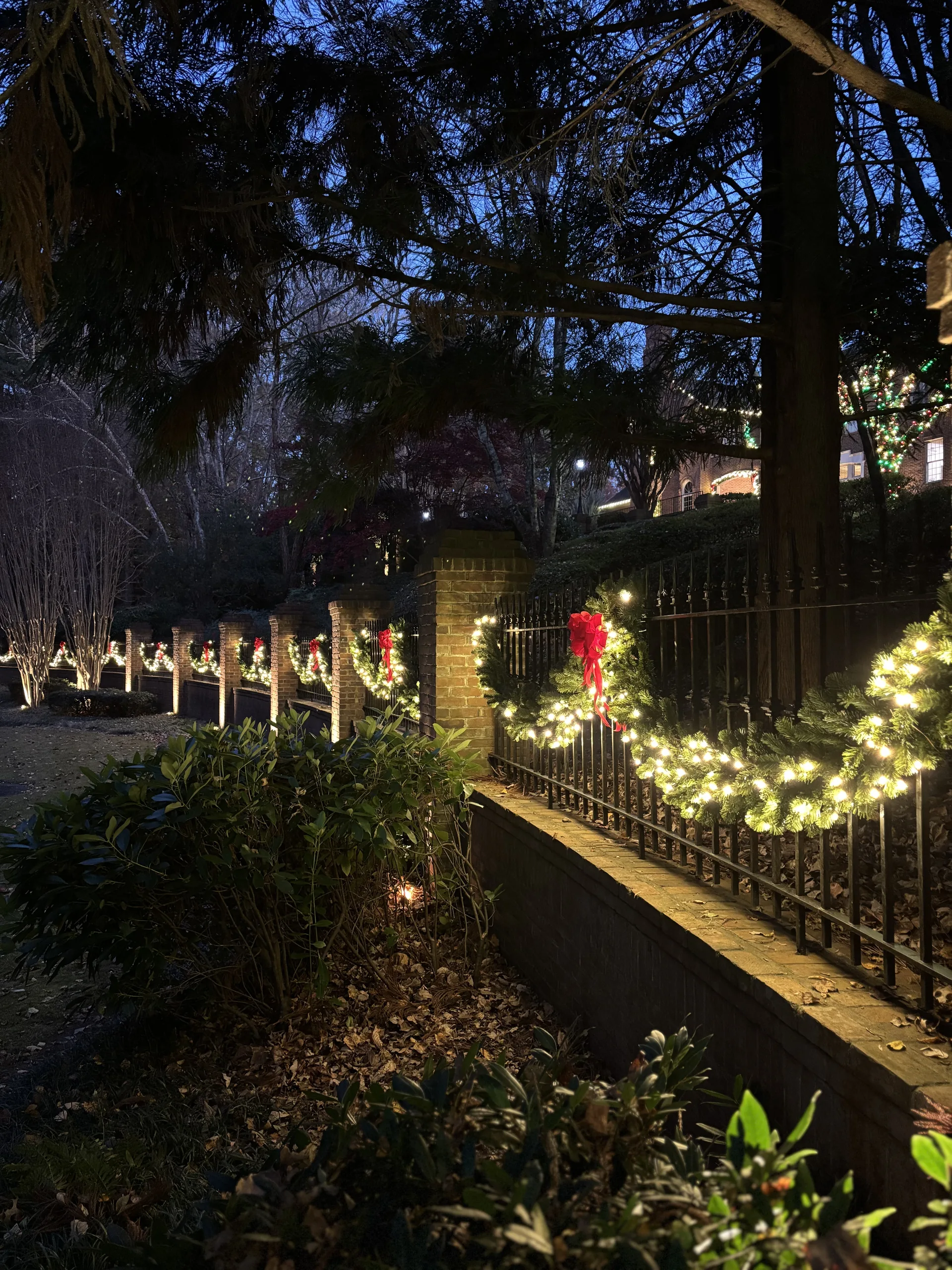 Pre-lit wreath and garland on a residential entry